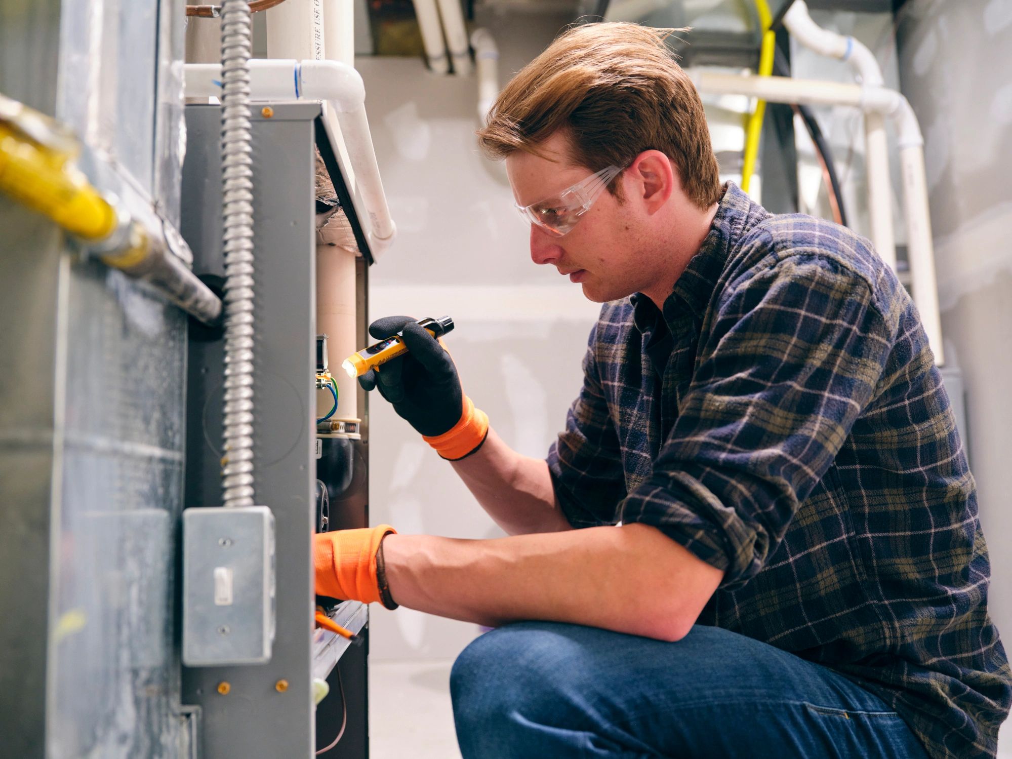 HVAC technician working on a residential furnace