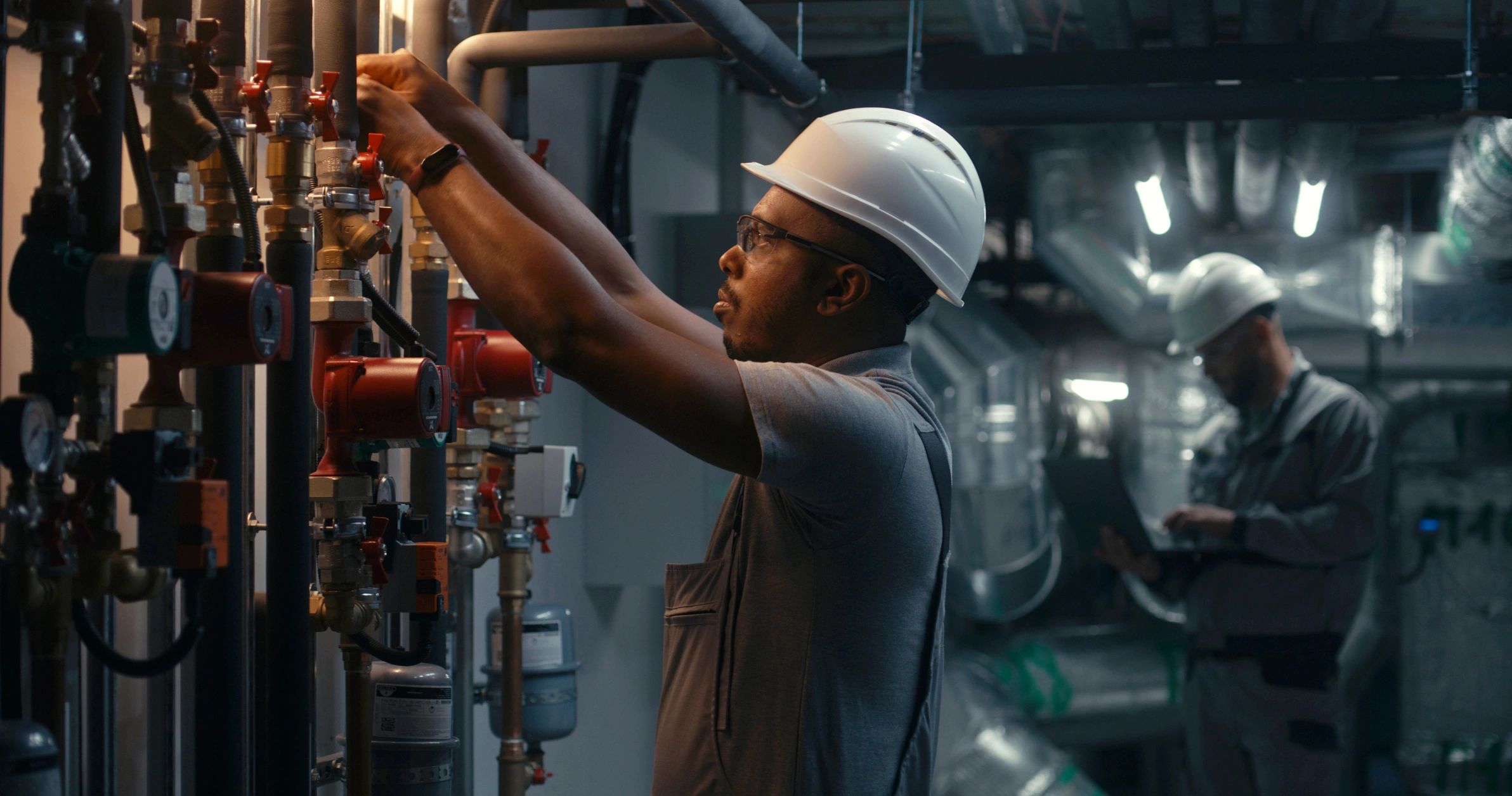 Technician inspecting equipment in an industrial setting